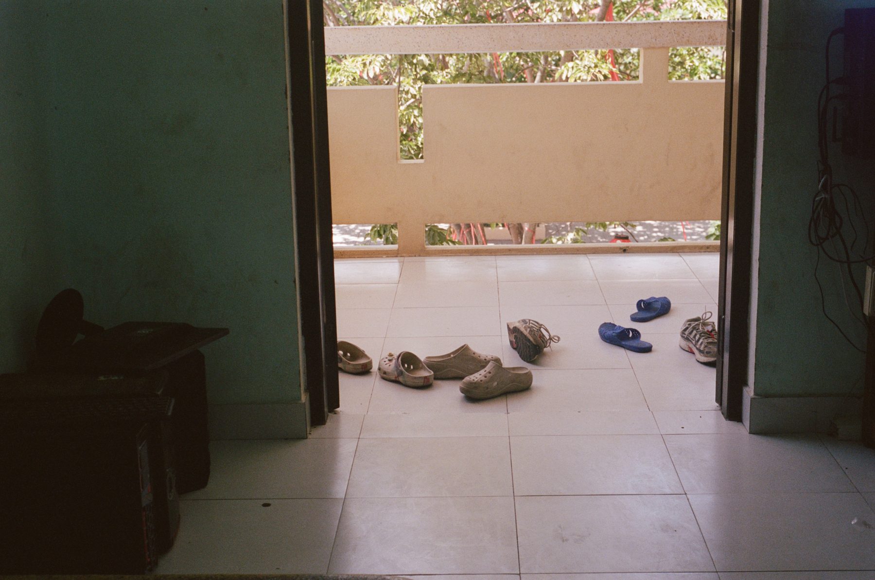Rows of sandals left outside a classroom door in Huế